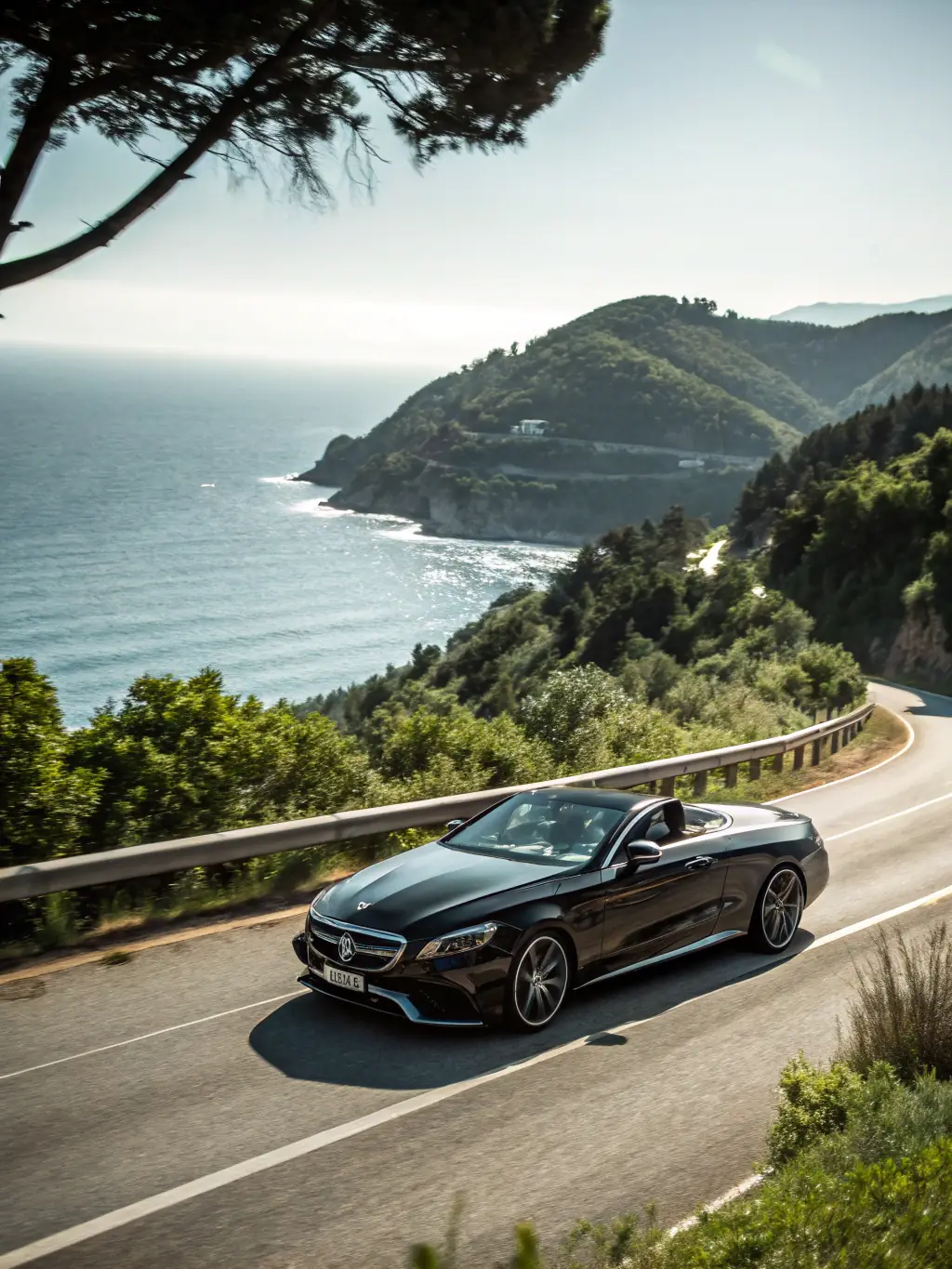 A private car is shown driving along the scenic coastal road of Antalya, providing a personalized transfer experience. The image should highlight flexibility and scenic beauty.