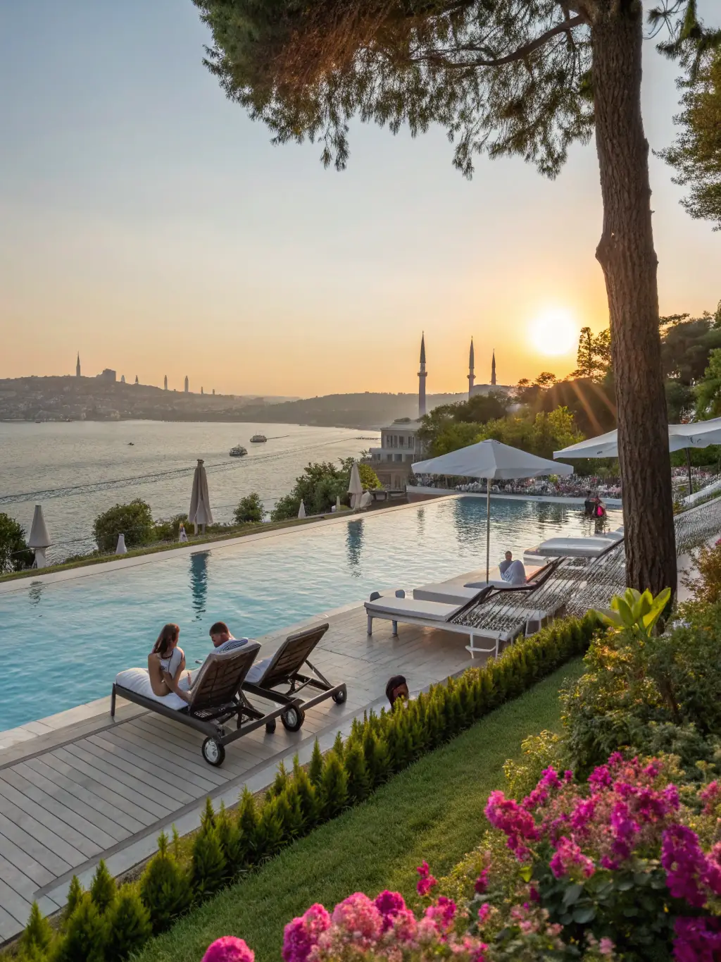 A luxurious beachfront hotel in Antalya, Turkey, featuring a large outdoor pool, palm trees, and guests enjoying the sun and sea.